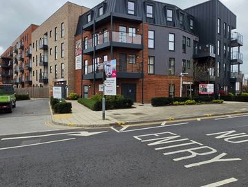 Modern apartment complex with clear 'No Entry' road markings.
