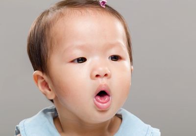 A surprised baby with an open mouth.