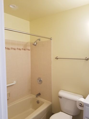 Full bathroom with tub and shower.
