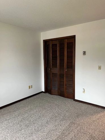 Bedroom with lighted closet.