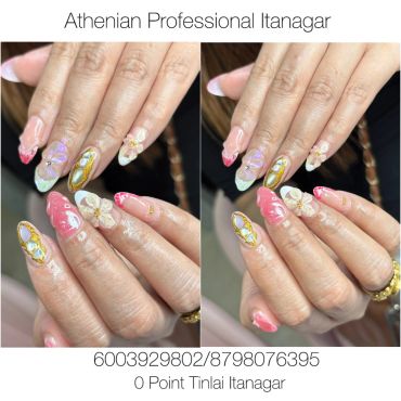 Elegant floral and gemstone nail art on manicured hands.