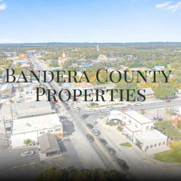 Aerial view of a town with the text Bandera County Properties.