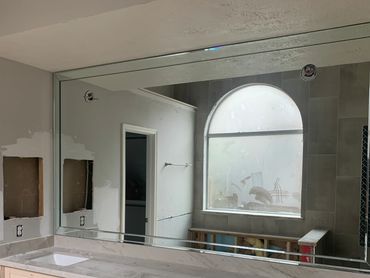 Beveled framed bathroom  mirror by Century Glass.