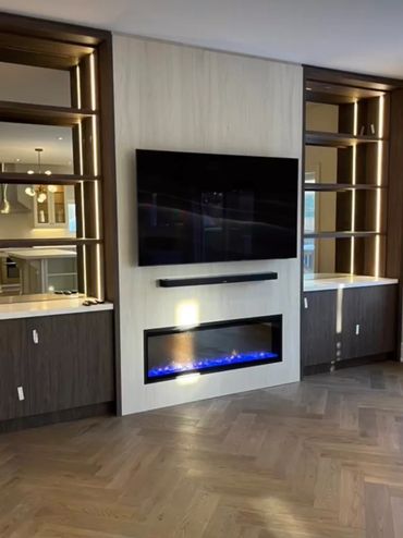 Modern living room setup with a mounted TV and electric fireplace.