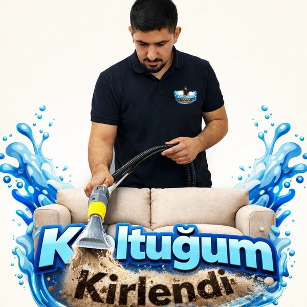 A man professionally cleaning a beige sofa with a vacuum tool.