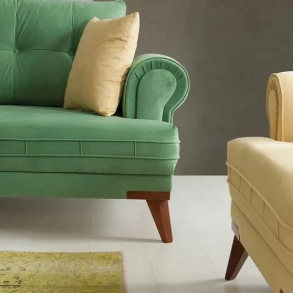 Green and yellow sofas with wooden legs in a modern living room.