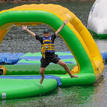 Kid jumping off an aqua park