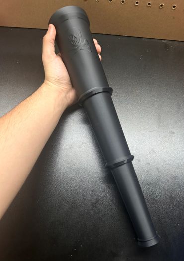 Hand holding a black pirate telescope with skull and crossbones.