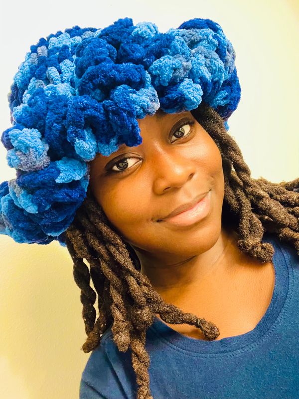 Black girl with blue crochet hat on her head