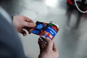 can applying a label to a bespoke colourful canned whisky cocktail