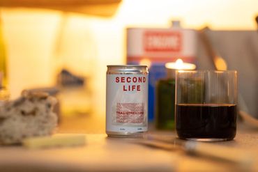 bespoke cocktail called Second Life against a glass with a dark red drink