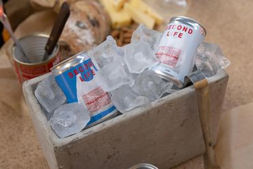 two custom canned cocktails in an ice well