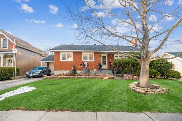 Brick house with green grass and blue sky