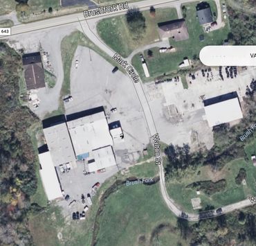 Aerial view of Brushfork Rd, Mark Circle, and Walton St with surrounding buildings and greenery.