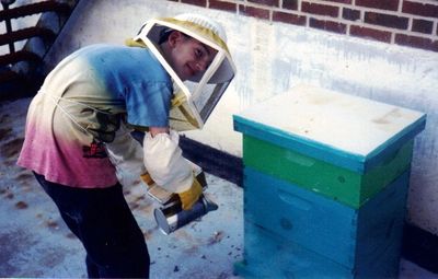 Young Anthony smoking a hive that he placed at a local school.