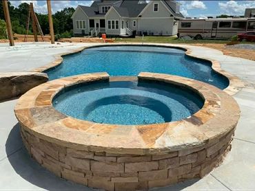 In ground pool with hot tub