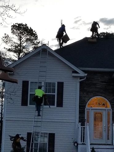 Our workers working on a roof