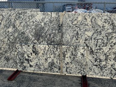 Large slabs of patterned granite stone displayed outdoors.