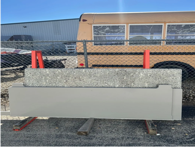 Two large stone slabs resting on wooden supports outdoors.