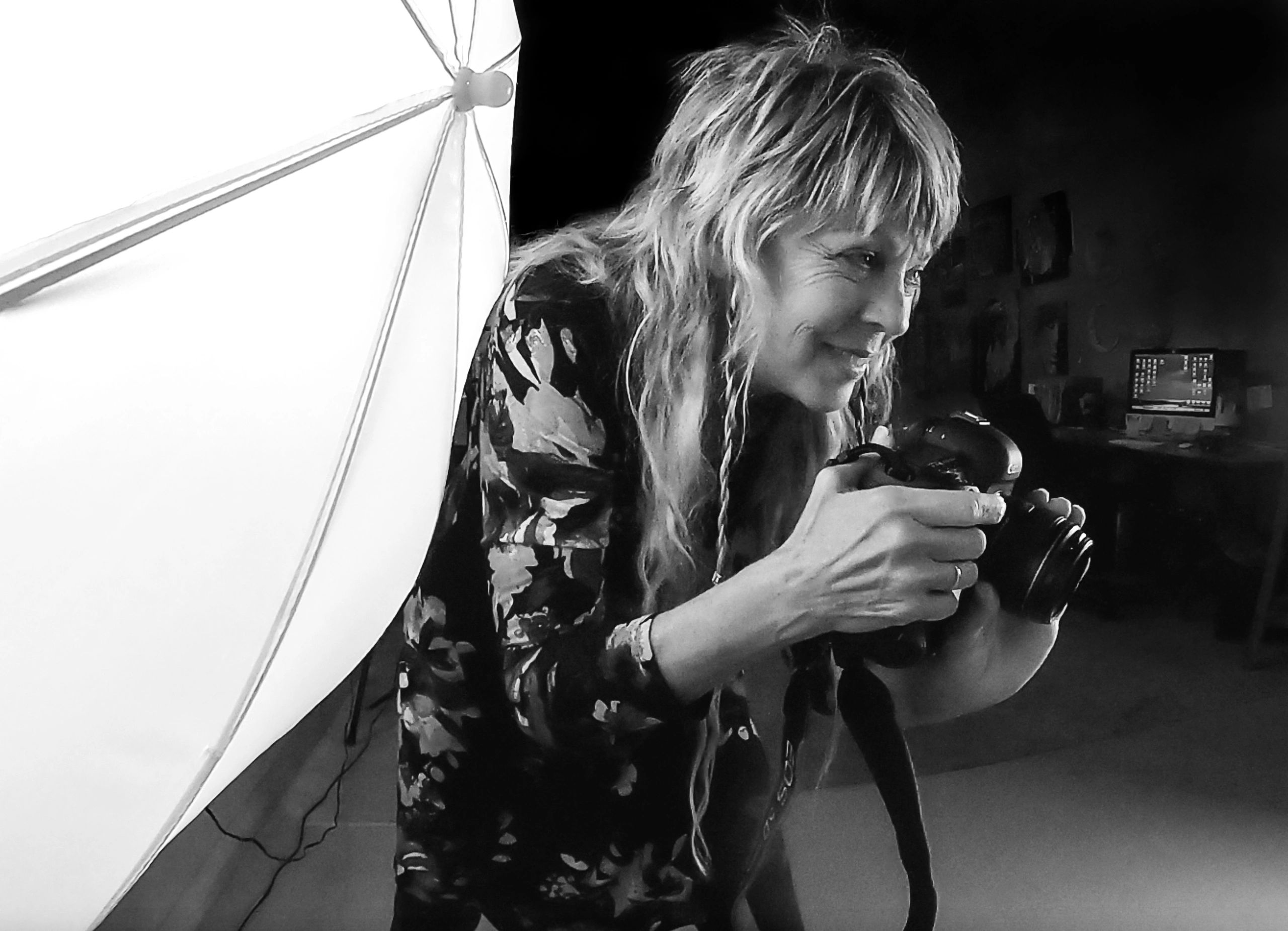 Photographer Linda Marie, shooting a portrait with her Canon 5D Mark IV camera in the studio.
