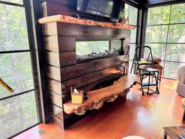 Live edge mantel over fireplace with live edge burl hearth in outdoor enclosed deck