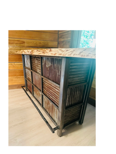 Live edge bartop with rustic tin panels and blacksmith twisted foot rest.