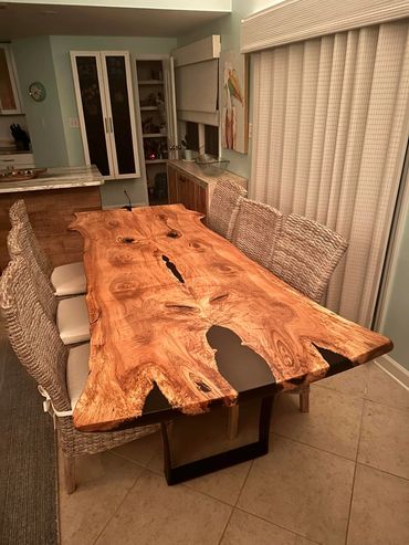 Live edge table with steel base. DIning room with blinds.