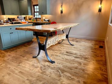 Maple live edge dining table with blacksmith curved base and stretcher