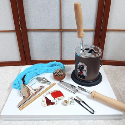 A collection of wasai kimono sewing tools on a white surface.