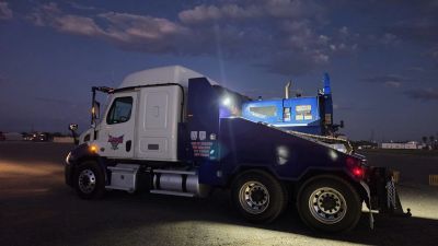 Unicon USA truck at night — manufactured home transport fleet