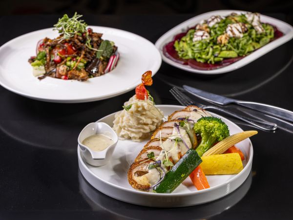 Gourmet chicken dish with mashed potatoes and vegetables.