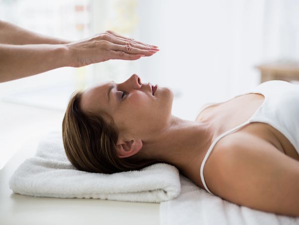 A woman sitting on her back at a reiki session