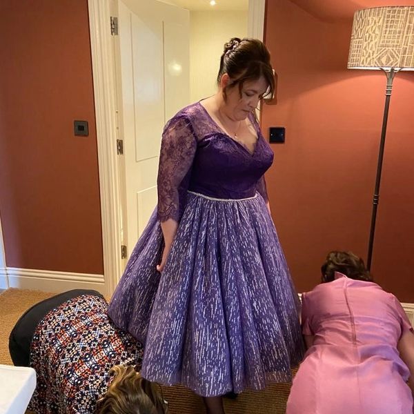 Bride in purple 1950's style wedding dress with lace and glitter tulle getting ready for the big day