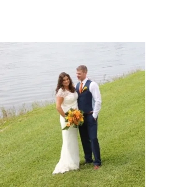 Ivory satin and lace wedding dress by a lake in Florida