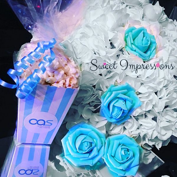 Popcorn in blue and white striped popcorn box