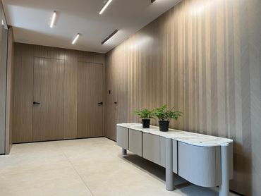 Minimalist room with wood-paneled walls and modern console table.
