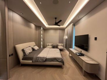 Modern bedroom with neutral tones and minimalist design.