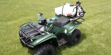 ATV sprayer with short tank saddles and dual boomless nozzles.
