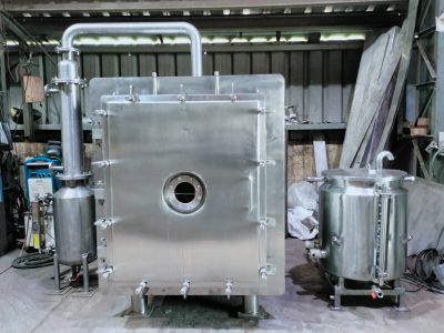 Industrial stainless steel machinery in a workshop.