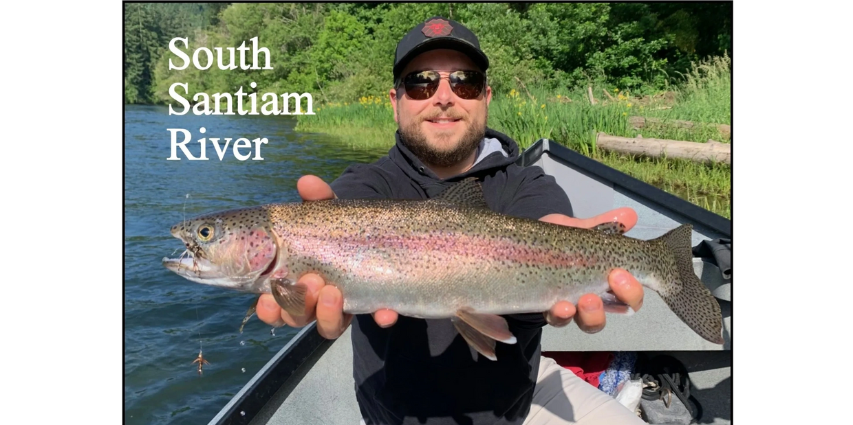Man holding a large rainbow trout on South Santiam River.