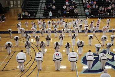 Lines of karate / martial arts/ Tang Soo Do students bowing to each other at event