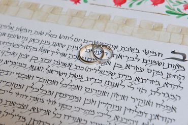Hebrew calligraphy ketubah and wedding rings