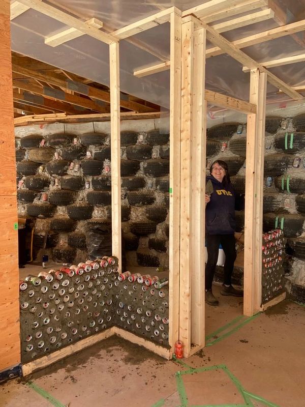 Framing in the interior walls using recycled pop and beer cans.
