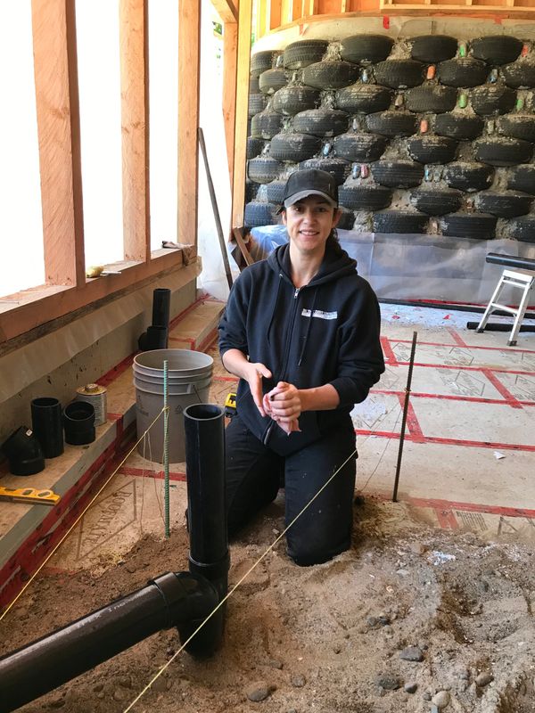 Our plumber! installing the below slab sewer pipes.