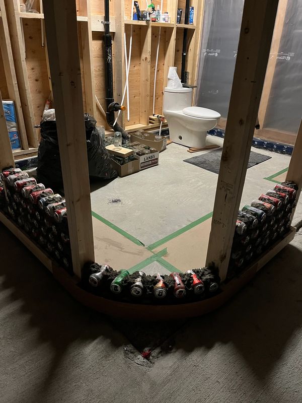 Framing in the master bathroom walls using aluminum pop and beer cans.