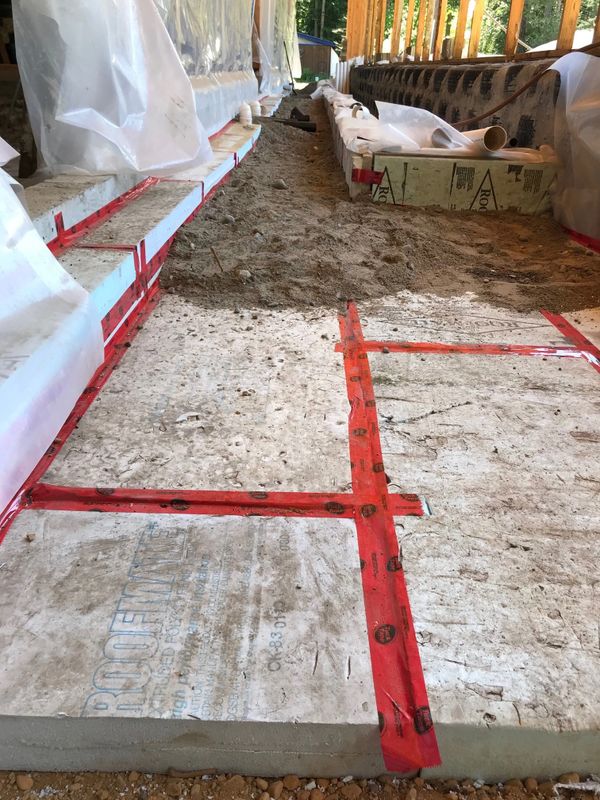 A layer of dirt is being added onto the recycled blue styrofoam that has been installed and taped.