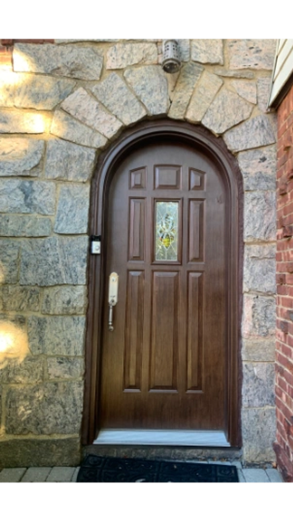 Round top arch steel entrance door.