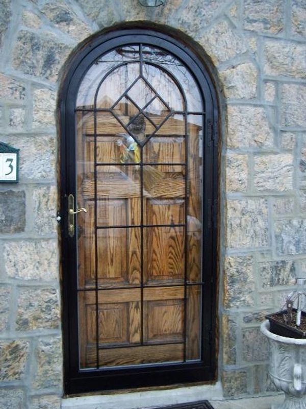 Security arch top entrance doors with round top.