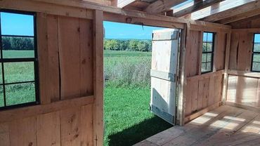 a custom made shed with the door open over looking the country side