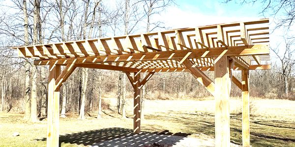 a custom built pergola on a concrete slab on a sunny day